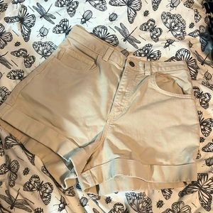 Cream coloured high waisted shorts.